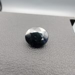A 3.81-carat natural blue sapphire from Kanchanaburi, Thailand, showcasing a deep royal blue color and a classic oval faceted cut, presented in a professional white jeweler's box.
