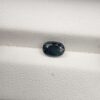 A 0.99-carat natural teal blue sapphire from Kanchanaburi, Thailand, with an oval faceted cut and a saturated blue-green color, presented in a professional jeweler's box.