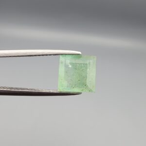 A natural 2.53-carat mint green emerald from Chithral Valley, Pakistan, featuring an octagon step cut with visible natural inclusions, held in professional jeweler's tweezers.