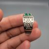 ​A handcrafted men's 925 sterling silver ring showcasing a vertical channel layout of 4 natural Swat Valley emeralds with a rich alpine green color profile, displayed from multiple professional angles on a reflective surface.