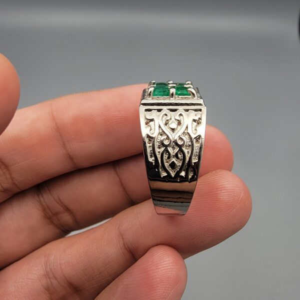 ​A handcrafted men's 925 sterling silver ring showcasing a vertical channel layout of 4 natural Swat Valley emeralds with a rich alpine green color profile, displayed from multiple professional angles on a reflective surface.