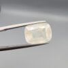 Official Galaxy Gemological Institute (GGI) Gemstone Report for a 7.18-carat Natural Colorless Sapphire. The certificate lists report number KHI260619001 and displays a digital product image of the loose, cushion-cut semi-transparent stone resting on a white reflective surface, emphasizing its clear, white icy tone and prominent step-and-mixed faceting architecture.