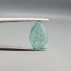 ​A 2.06-carat natural Colombian Emerald gemstone held vertically in professional metal gemstone tweezers against a smooth gray studio background. The loose gem is fashioned into a graceful pear shape, displaying a highly authentic, transparent mint-to-forest green core filled with dense, raw internal mountain fissures, natural inclusions, and soft organic mineral cracks.