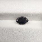 An official authenticity identification card from the Jaipur Gemological Lab for Specimen No. 5370170, certifying a 1.27-carat Natural Black Diamond. The lab certificate displays full technical data, including measurements of 8.98 x 3.19 mm, a marquise shape, an absolute hardness rating of 10, and a small photographic insert showing the faceted, eye-like black diamond.