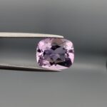 ​A high-clarity 5.22-carat natural Brazilian Amethyst gemstone beautifully presented in a luxury white-cushioned black leatherette display box. The loose gem showcases a brilliant cushion mixed cut with elegantly rounded corners, displaying an exceptionally rich, deep violet-purple color profile with magnificent internal light performance and sharp facet symmetry.