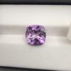 ​A high-clarity 4.21-carat natural Brazilian Amethyst gemstone beautifully presented in a luxury white-cushioned black leatherette display box. The loose gem showcases a brilliant cushion cut with softly rounded rectangular edges, displaying a uniform, bright violet-purple color profile with magnificent internal light performance and sharp facet symmetry.