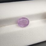 A rare, high-clarity 2.81-carat natural Ceylon Purple Sapphire gemstone nestled securely in a luxury white-cushioned black display box. The loose gem showcases an elegant faceted oval cut, displaying a beautifully saturated deep violet-purple to royal purple body color with outstanding internal light refraction and pristine facet symmetry.