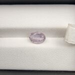 A premium, high-clarity 1.84-carat natural Ceylon Light Purple Sapphire gemstone nestled securely in a luxury white-cushioned black display box. The loose gem showcases an elegant faceted oval cut, displaying a delicate, brightly saturated light violet-purple body color with excellent internal light refraction and pristine facet symmetry.