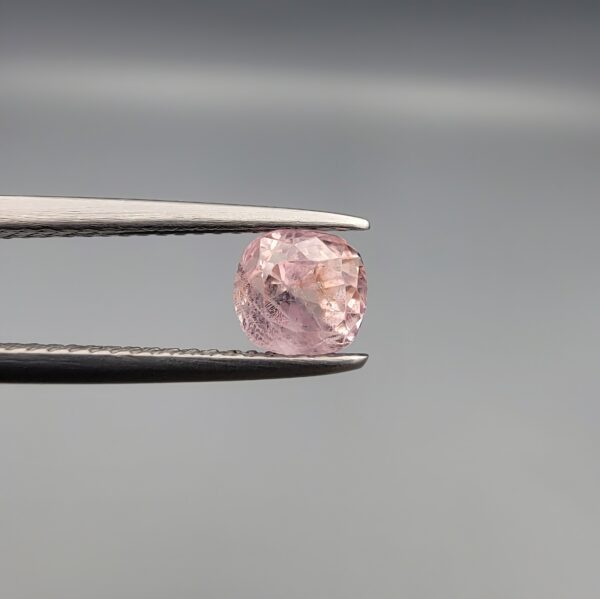 A rare, high-clarity 1.26-carat natural Ceylon Pink Sapphire gemstone nestled securely in a luxury white-cushioned display box. The loose gem showcases an elegant faceted cushion cut with beautifully balanced crown facets, displaying an intensely vibrant, glowing pink body color with pristine facet symmetry, zero enhancements, and exceptional internal light reflection.