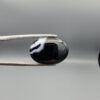 "Natural Black Banded Agate Sulemani Aqeeq oval cabochon gemstone 15.35 carat held in tweezers showing white banding"