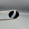 "Natural Black Banded Sulemani Aqeeq Agate oval cabochon gemstone 14.27 carat with curved white and brown band held in tweezers"