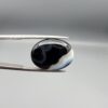 "Natural Black Banded Sulemani Aqeeq Agate oval cabochon gemstone 14.03 carat with horizontal white and brown wave band held in tweezers"