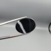 "Natural Black Banded Sulemani Aqeeq Agate oval cabochon gemstone 15.08 carat with vertical white and brown side band held in tweezers"