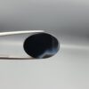 "Natural Black Banded Sulemani Aqeeq Agate oval cabochon gemstone 14.25 carat, plain black front with wide white and grey band on reverse, held in tweezers"