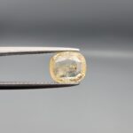 "Natural unheated Yellow Sapphire Pukhraj gemstone 2.22 carat cushion cut from Sri Lanka Ceylon held in tweezers showing natural inclusions"