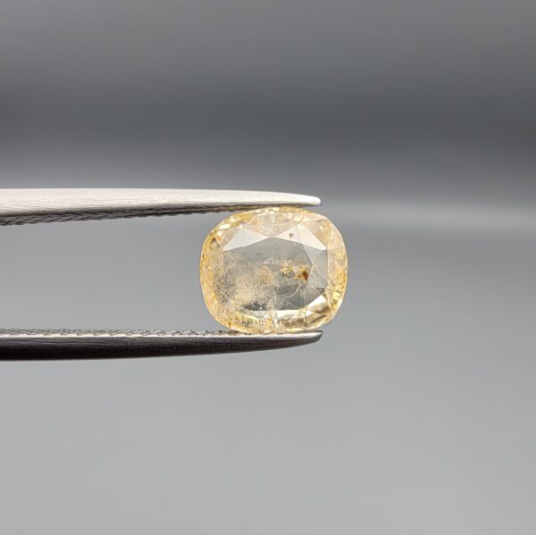 "Natural unheated Yellow Sapphire Pukhraj gemstone 2.22 carat cushion cut from Sri Lanka Ceylon held in tweezers showing natural inclusions"