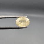 "Natural unheated Yellow Sapphire Pukhraj gemstone 2.13 carat cushion cut from Sri Lanka Ceylon held in tweezers showing silky natural inclusions"