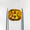 High-resolution photograph of an official Galaxy Gemological Institute (GGI) Gemstone Report certificate (No. KHI2609940326) dated 14 September 2026 for a 4.45-carat transparent Orangish Yellow natural cushion mixed-cut Yellow Sapphire from Madagascar.