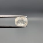 "Natural unheated Yellow Sapphire Pukhraj gemstone 2.35 carat cushion cut from Sri Lanka Ceylon held in tweezers showing near-white color and natural crystal inclusions"