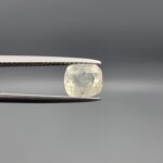 "Natural unheated Yellow Sapphire Pukhraj gemstone 1.82 carat cushion cut from Sri Lanka Ceylon held in tweezers showing pale color and visible natural crystal inclusion"
