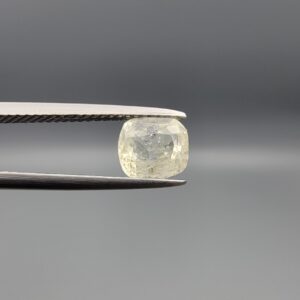 "Natural unheated Yellow Sapphire Pukhraj gemstone 1.82 carat cushion cut from Sri Lanka Ceylon held in tweezers showing pale color and visible natural crystal inclusion"