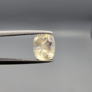 "Natural unheated Yellow Sapphire Pukhraj gemstone 1.99 carat cushion cut from Sri Lanka Ceylon held in tweezers showing bright faceting and natural inclusions"