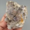 "Natural Fluorite crystal cluster specimen 1313 grams from Balochistan Pakistan showing large cubic purplish gray crystals with yellow limonite staining, held in hand"