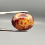 Natural Fire Agate oval cabochon 20.61 carat gemstone from Iran with red amber and orange tones