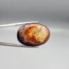 Natural Surkh Aqeeq oval cabochon 35.55 carat with translucent red black and cream marbled pattern from Iran