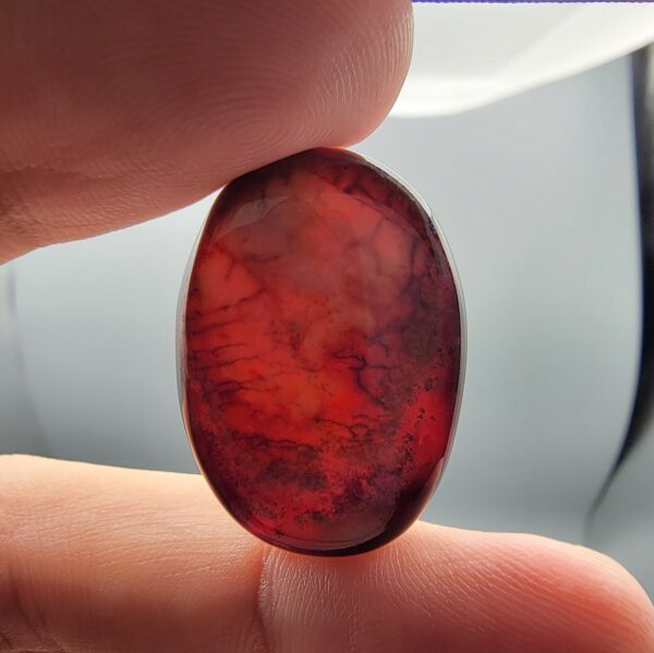 Natural Surkh Aqeeq oval cabochon 35.55 carat with translucent red black and cream marbled pattern from Iran