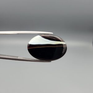 Natural Black Sulemani Agate oval cabochon 21.86 carat gemstone from Iran with white banded eye stripe