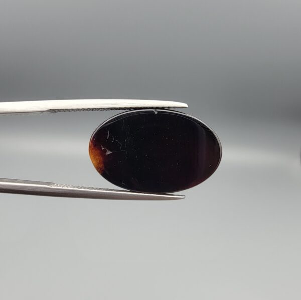 Natural black chalcedony agate oval cabochon 12.03 carat with cream and moss-green mineral inclusion from Iran