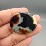 Natural black Sulemani agate oval cabochon 86.99 carat with natural pareidolia baby and cat shaped inclusions from Iran