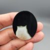 Natural black Sulemani agate oval cabochon 86.99 carat with natural pareidolia baby and cat shaped inclusions from Iran