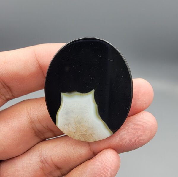 Natural black Sulemani agate oval cabochon 86.99 carat with natural pareidolia baby and cat shaped inclusions from Iran