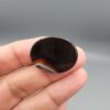 Natural black Sulemani agate oval cabochon 36.64 carat with natural pareidolia alien face pattern from Iran