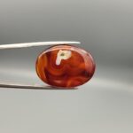 Natural Surkh Aqeeq oval cabochon 27.13 carat translucent red agate with natural white letter P shaped inclusion from Iran