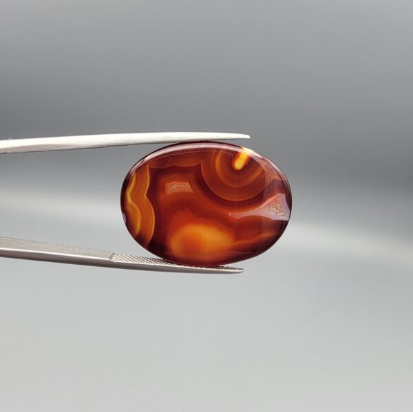 Natural Surkh Aqeeq oval cabochon 27.13 carat translucent red agate with natural white letter P shaped inclusion from Iran