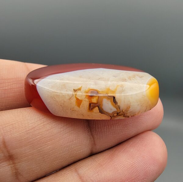 Natural multi-color Sulemani agate oval cabochon 69.42 carat with translucent red and cream mottled zones from Iran