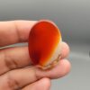 Natural multi-color Sulemani agate oval cabochon 69.42 carat with translucent red and cream mottled zones from Iran