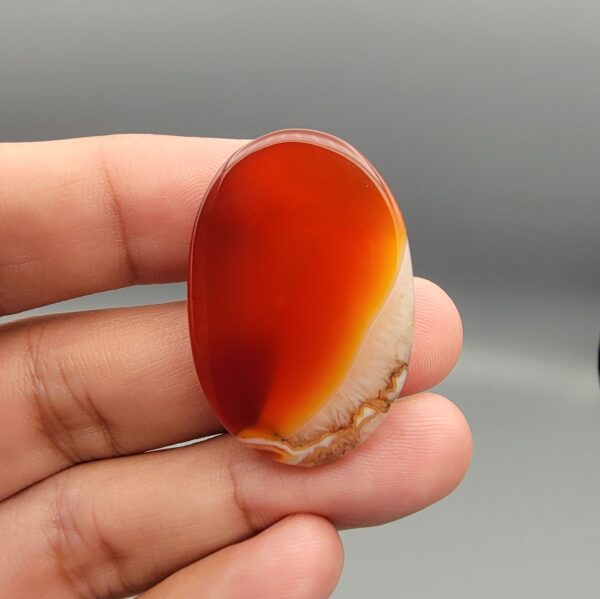 Natural multi-color Sulemani agate oval cabochon 69.42 carat with translucent red and cream mottled zones from Iran