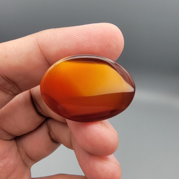 Natural multi-color Sulemani agate oval cabochon 70 carat with red orange and white banded pattern from Iran