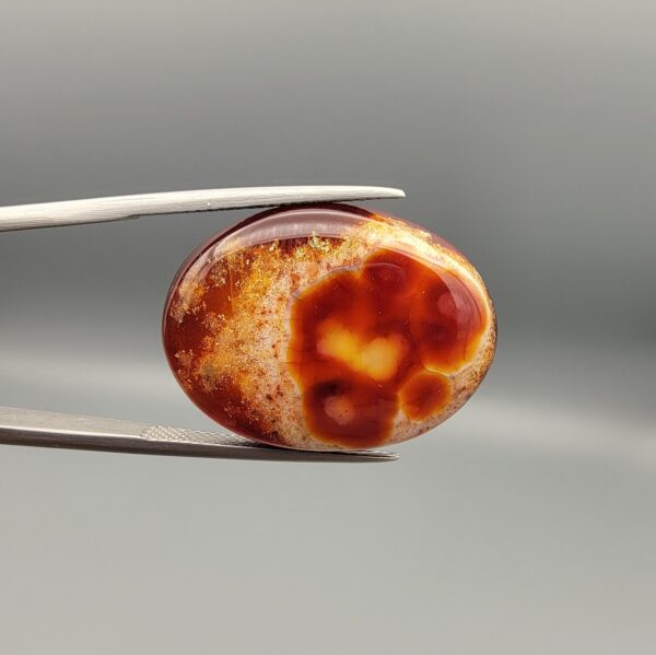 Natural Fire Agate oval cabochon 25.74 carat with yellow orange and red mottled pattern from Iran
