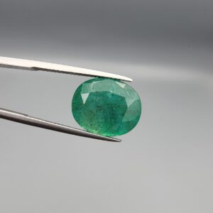 Natural green Zambian emerald oval faceted gemstone 8.75 carat with visible mineral inclusions