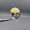 Studio photograph of a handcrafted men's 925 sterling silver ring featuring a massive 8+ carat natural faceted Ethiopian opal center stone with intricate vintage Turkish scrollwork on the shoulders.