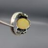 Studio photograph of a handcrafted men's 925 sterling silver ring featuring a massive 8+ carat natural faceted Ethiopian opal center stone with intricate vintage Turkish scrollwork on the shoulders.