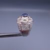 Studio close-up photograph of a handcrafted 925 sterling silver men's ring featuring a central 2+ carat blue sapphire surrounded by a geometric star design pavé-set with natural diamonds.