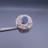 Studio close-up photograph of a handcrafted 925 sterling silver men's ring featuring a central 2+ carat blue sapphire surrounded by a geometric star design pavé-set with natural diamonds.