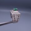 Studio close-up photograph of a handcrafted size 23 men's 925 sterling silver ring centered with a 1.60 carat oval emerald framed by a double rectangular tier of pavé-set natural diamonds.