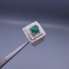 Studio close-up photograph of a handcrafted size 23 men's 925 sterling silver ring centered with a 1.60 carat oval emerald framed by a double rectangular tier of pavé-set natural diamonds.